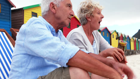 Senior-couple-interacting-with-each-other-at-the-beach