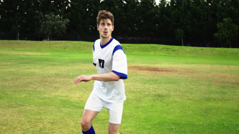 Football-player-striking-a-ball-in-the-field