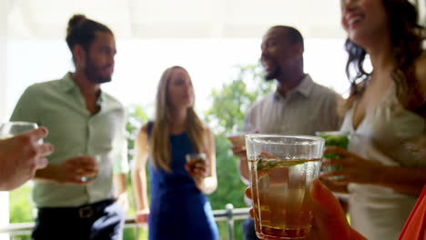 Group-of-friends-interacting-with-each-other-while-having-drinks