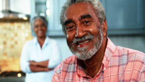 Senior-couple-standing-in-kitchen