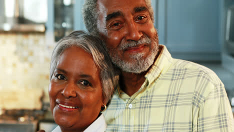 Senior-couple-standing-in-kitchen