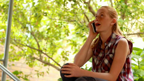 Happy-schoolgirl-using-mobile-phone