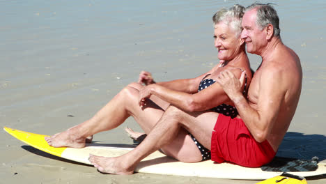 Senior-couple-sitting-on-the-beach