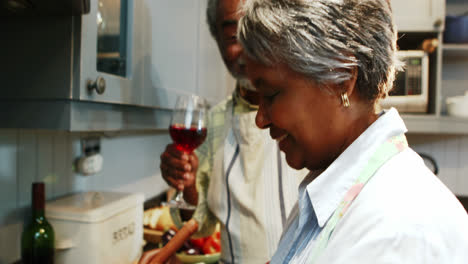 Senior-couple-preparing-food-in-kitchen