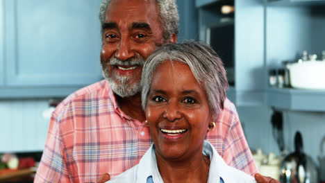 Senior-couple-standing-in-kitchen