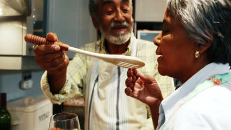 Senior-couple-preparing-food-in-kitchen