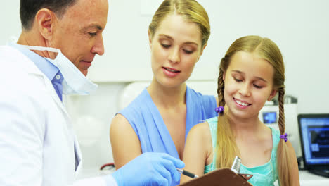 Dentist-interacting-with-young-patient