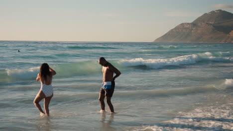 Couple-playing-at-the-beach