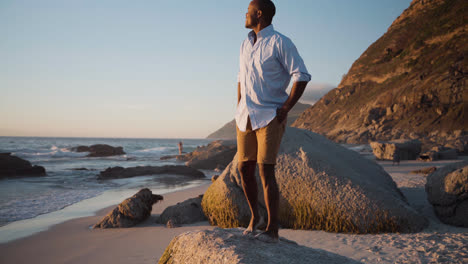 Man-standing-on-a-rock