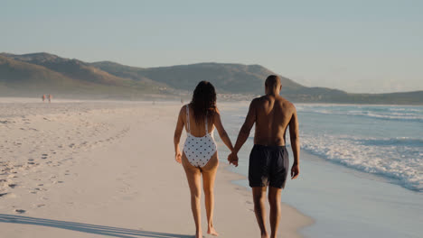 Couple-walking-on-the-seashore