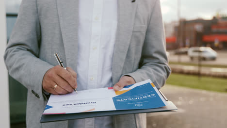 Businessman-signing-certificate