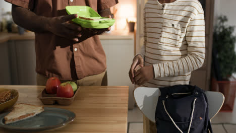 Man-preparing-lunch-box