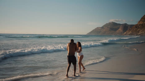 Couple-playing-at-the-beach