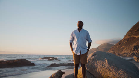 Man-standing-on-a-rock