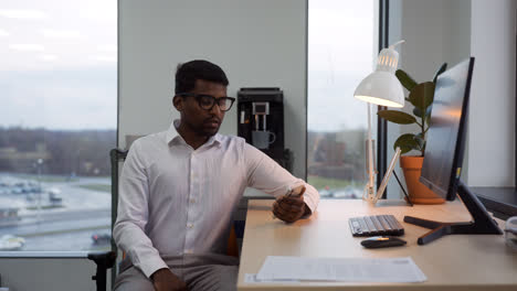 Indian-man-using-the-phone-at-the-office