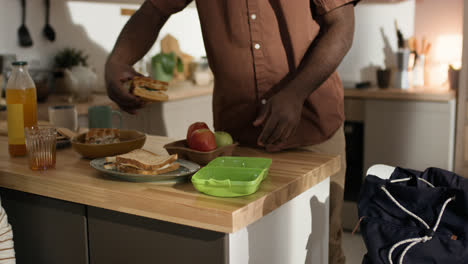 Man-preparing-lunch-box