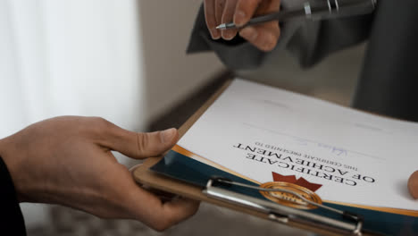 Mujer-Firmando-Certificado-De-Logro