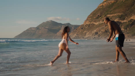 Couple-playing-at-the-beach