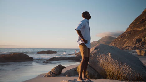 Man-standing-on-a-rock