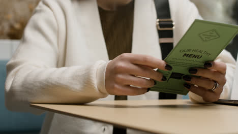 Woman-looking-at-menu