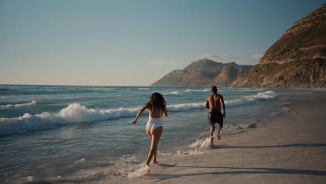 Couple-playing-at-the-beach