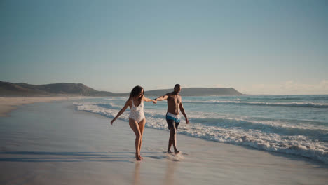 Couple-playing-at-the-beach