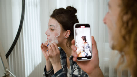 Young-woman-applying-a-face-mask