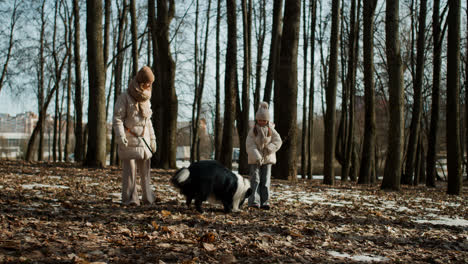 Mom-and-daughter-playing-with-dog