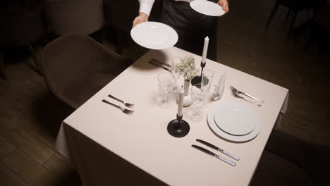 Waiter-setting-a-dining-table