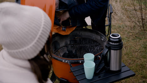 Man-preparing-BBQ-grill