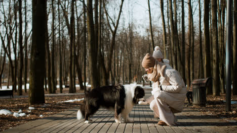 Mom-and-daughter-playing-with-dog