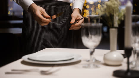 Waiter-setting-a-dining-table