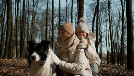 Mom-and-daughter-playing-with-dog