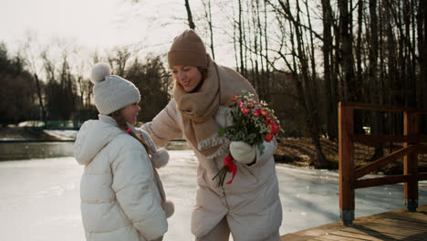 Girl-giving-flowers-to-her-mom