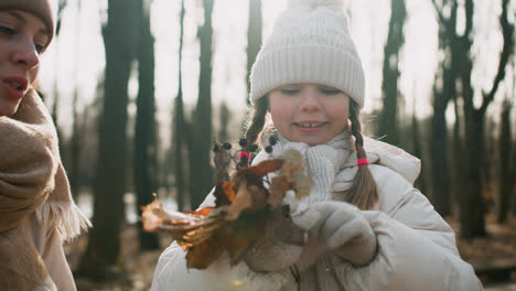 Little-girl-holding-dried-leaves