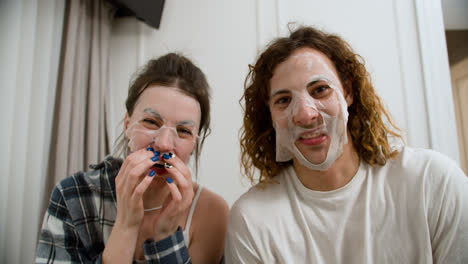 Couple-with-face-mask-recording-a-funny-video