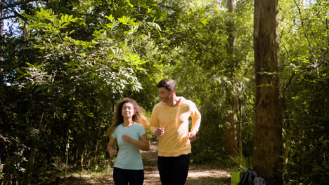 Happy-couple-running-in-the-forest