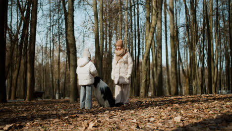 Mom-and-daughter-playing-with-dog