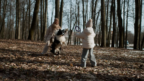 Mom-and-daughter-playing-with-dog