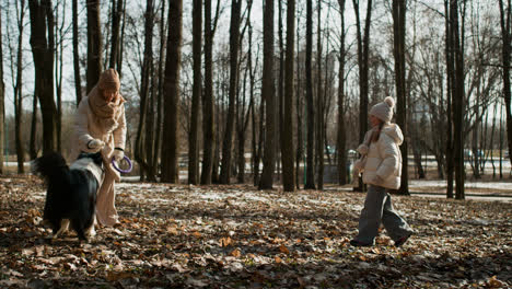 Mom-and-daughter-playing-with-dog