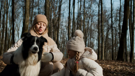 Mom-and-daughter-playing-with-dog