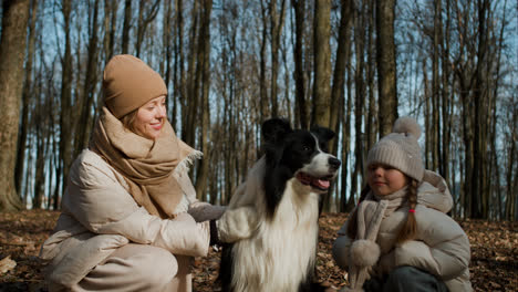 Mom-and-daughter-playing-with-dog