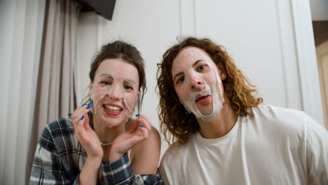 Couple-with-face-mask-recording-a-funny-video