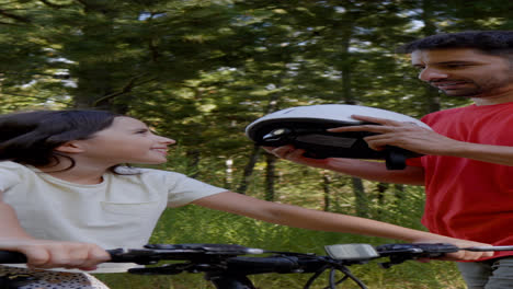 Dad-putting-helmet-on-daughter