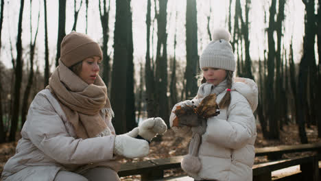 Little-girl-holding-dried-leaves