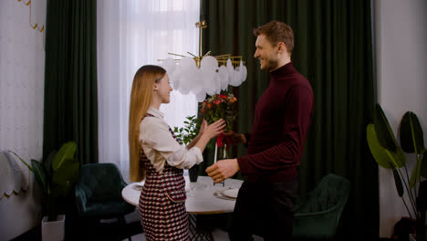 Man-giving-flowers-to-wife