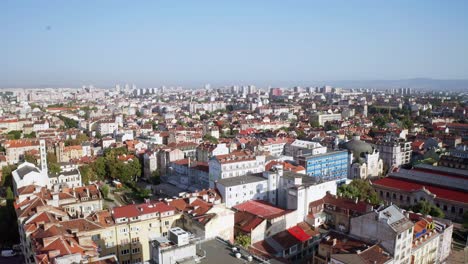 Aerial-forward-skyline-Sofia,-Bulgaria-on-a-sunny-summer-day,-copy-space