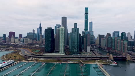 Aerial-tracking-shot-in-front-of-the-New-Eastside-skyline,-gloomy-day-in-Chicago