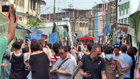 Maeklong-Railway-Market-Talad-Rom-Hub-tourists-waiting-for-train-to-pass