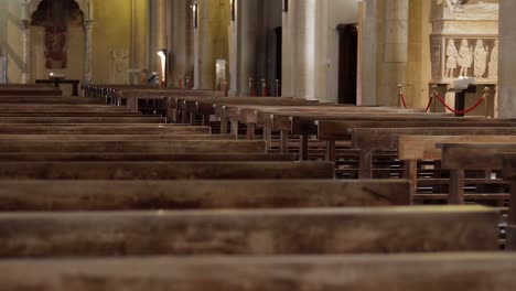 Rows-of-empty-wooden-pews-in-peaceful-spiritual-Holy-Catholic-church-of-Gesu-Nuovo